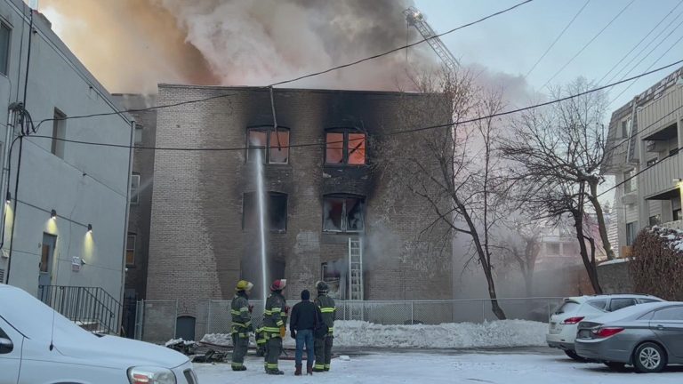Minneapolis firefighters respond to a fire at a boarded-up apartment building
